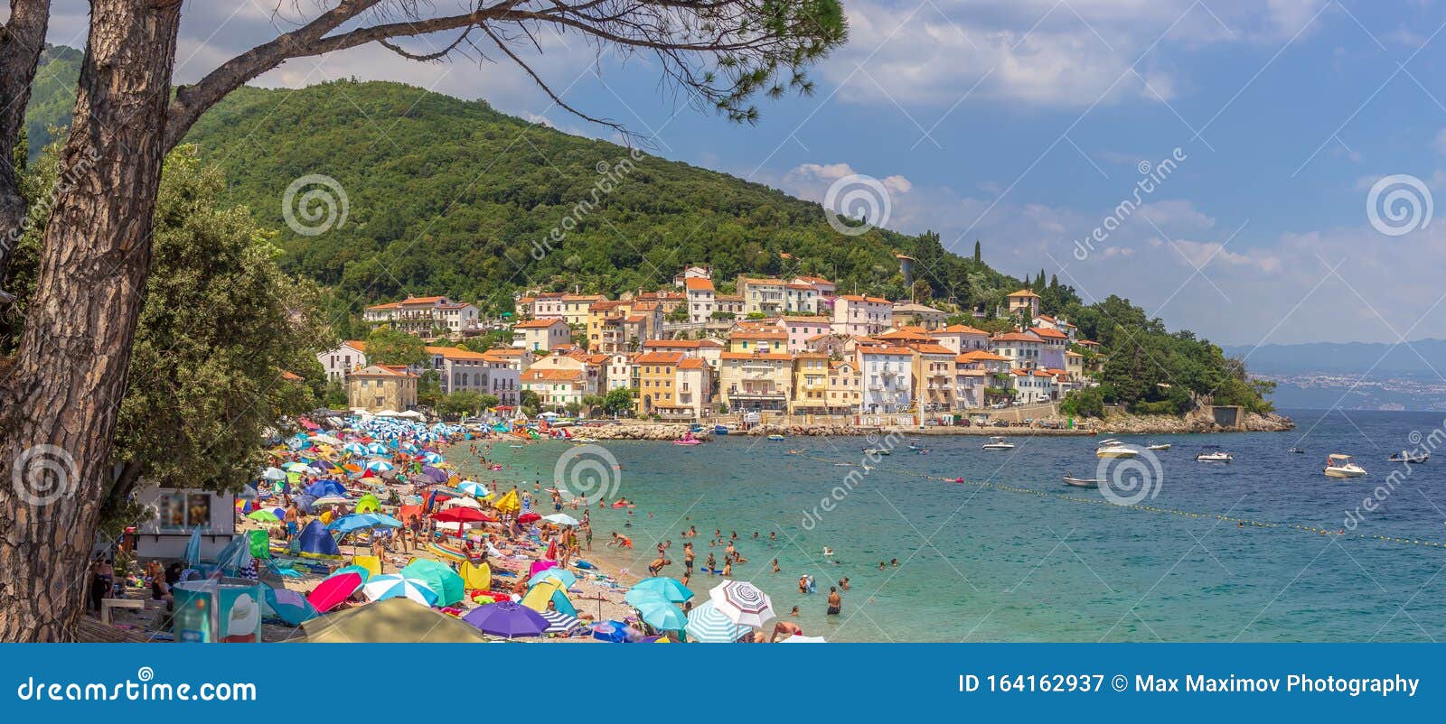moÃÂ¡Ãâ¡eniÃÂka draga, croatia - beautiful water colors and old town and coastline at the adriatic sea beach full of people
